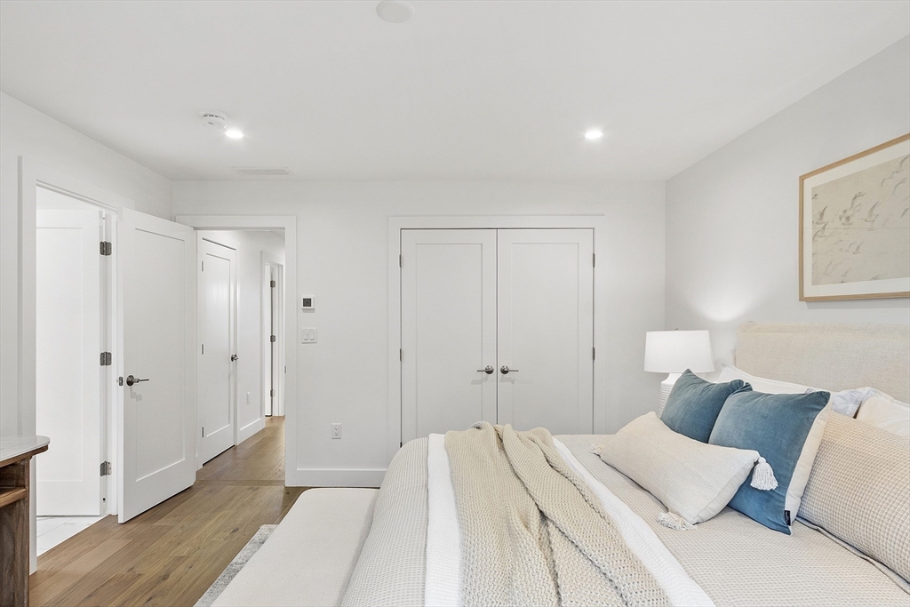 225 Middlesex Turnpike, Unit 106 Burlington, MA 01803 - Photo 19 of 23 a spacious bedroom with a bed and a painting on the wall