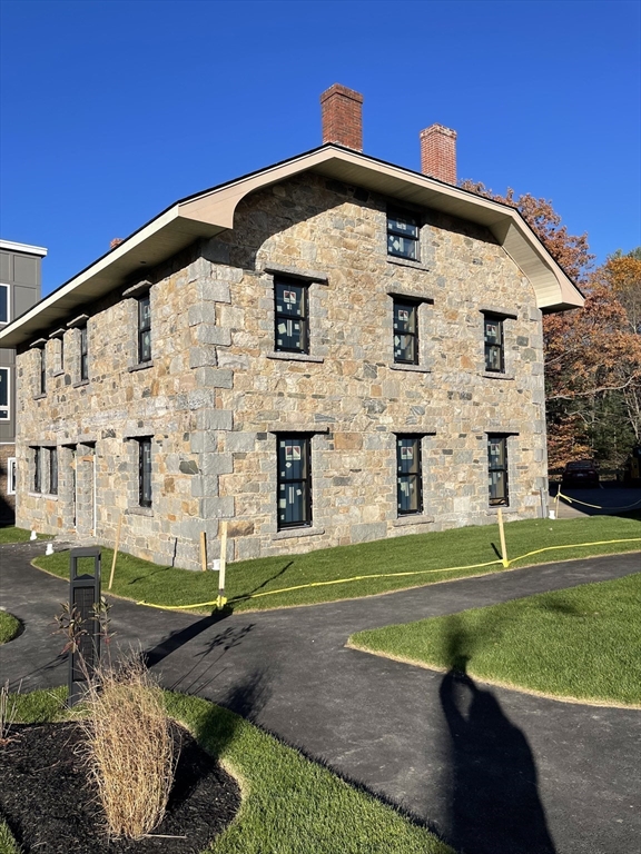 225 Middlesex Turnpike, Unit 106 Burlington, MA 01803 - Photo 4 of 23 a front view of a house with a yard