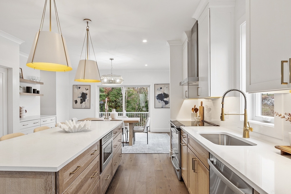 225 Middlesex Turnpike, Unit 106 Burlington, MA 01803 - Photo 7 of 23 a kitchen with counter top a sink a stove and a window