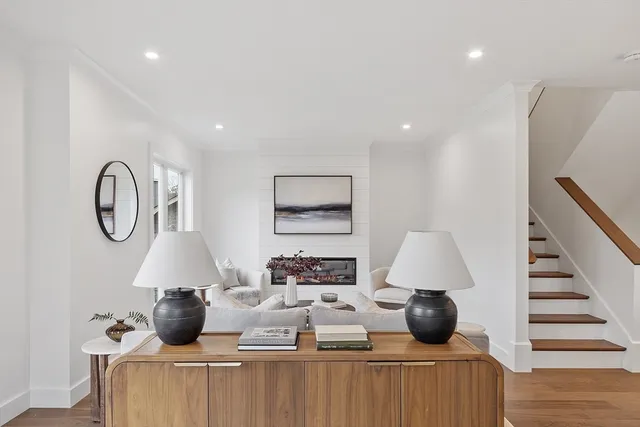 a living room with furniture and a kitchen