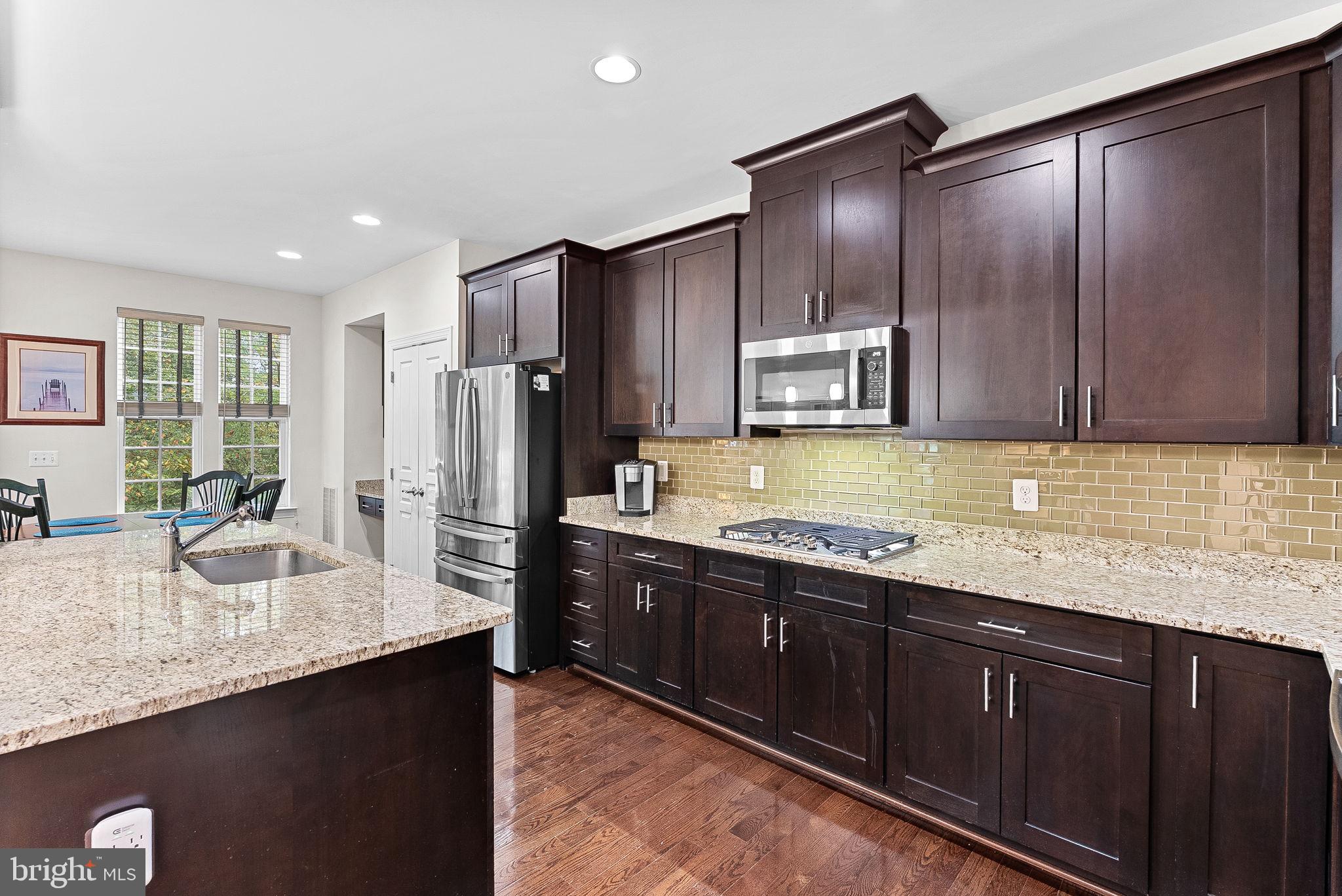 20281 Center Brook Square Sterling, VA 20165 - Photo 14 of 51 a kitchen with stainless steel appliances granite countertop wooden cabinets a refrigerator and a sink