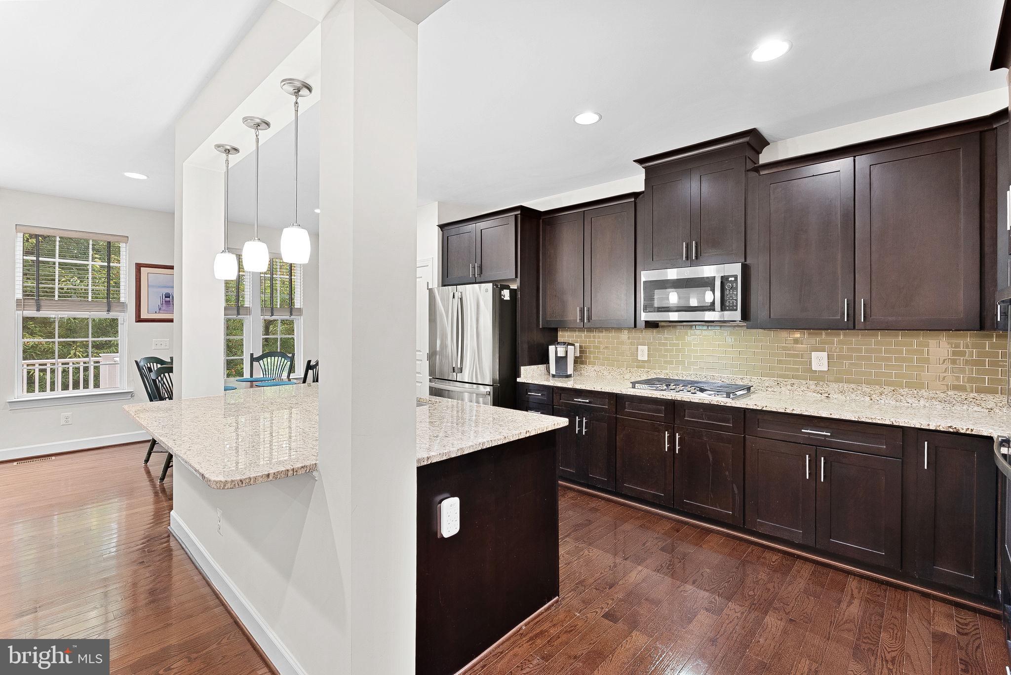 20281 Center Brook Square Sterling, VA 20165 - Photo 15 of 51 a large kitchen with kitchen island a sink stainless steel appliances and cabinets