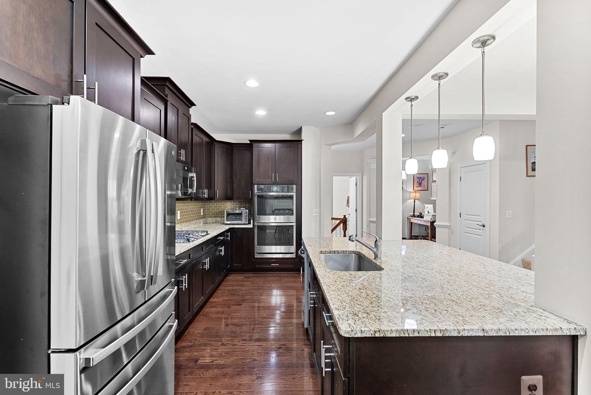 20281 Center Brook Square Sterling, VA 20165 - Photo 17 of 51 a kitchen with stainless steel appliances granite countertop a refrigerator a oven and white cabinets