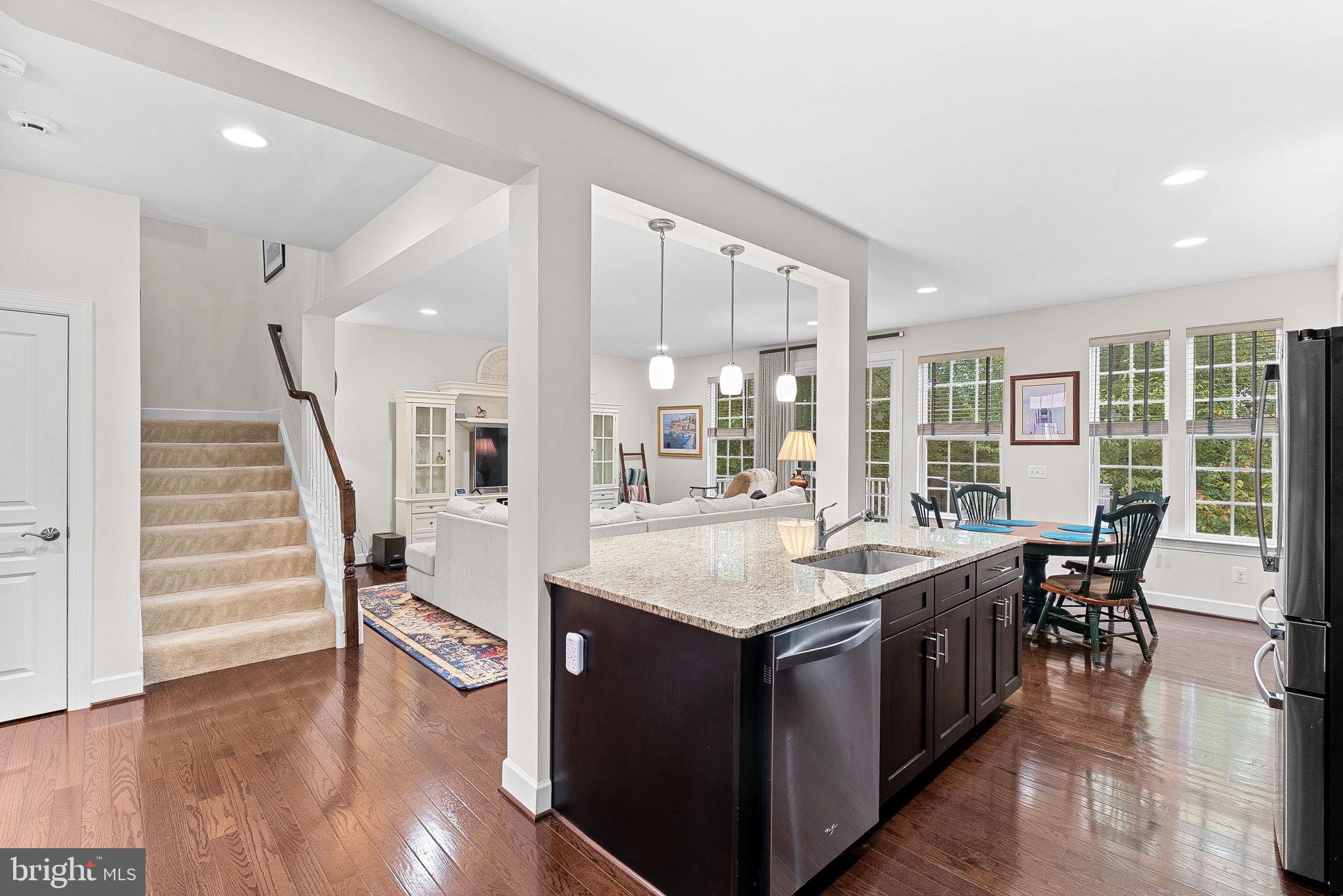 20281 Center Brook Square Sterling, VA 20165 - Photo 19 of 51 a dining hall with stainless steel appliances kitchen island a table and chairs