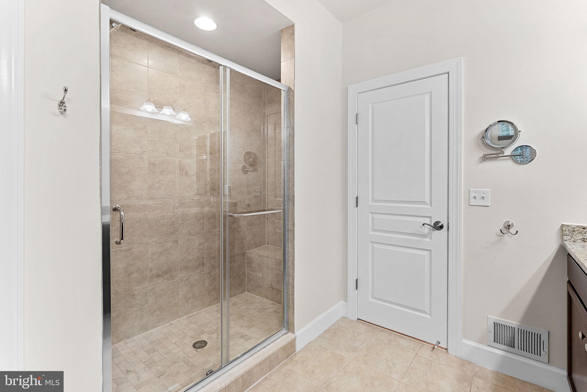 20281 Center Brook Square Sterling, VA 20165 - Photo 27 of 51 a bathroom with a glass shower door