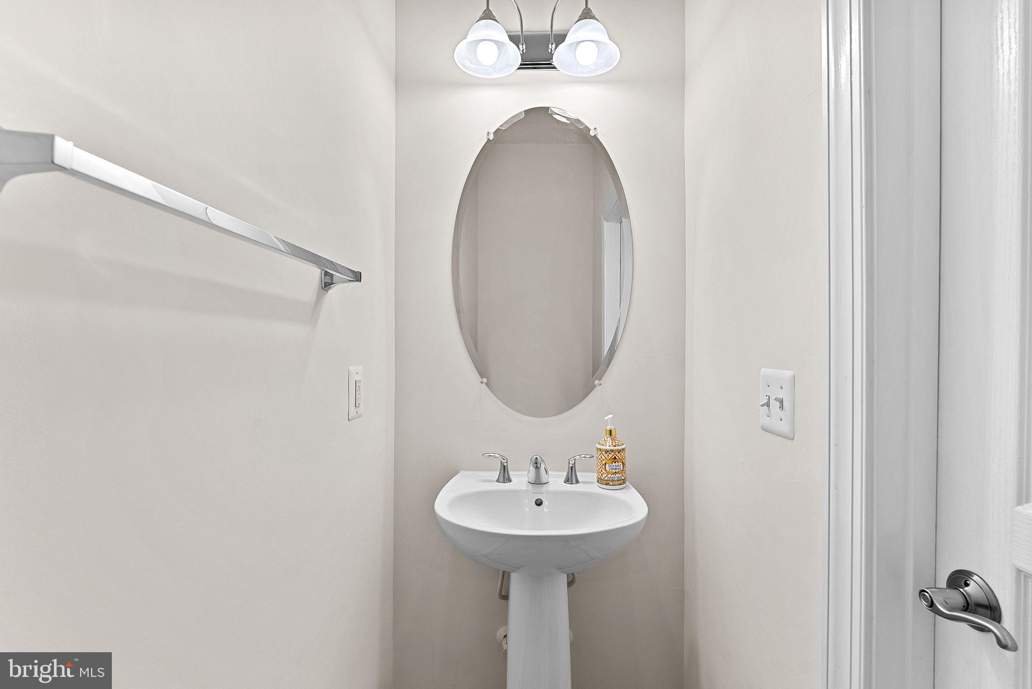 20281 Center Brook Square Sterling, VA 20165 - Photo 36 of 51 a bathroom with a sink and a mirror