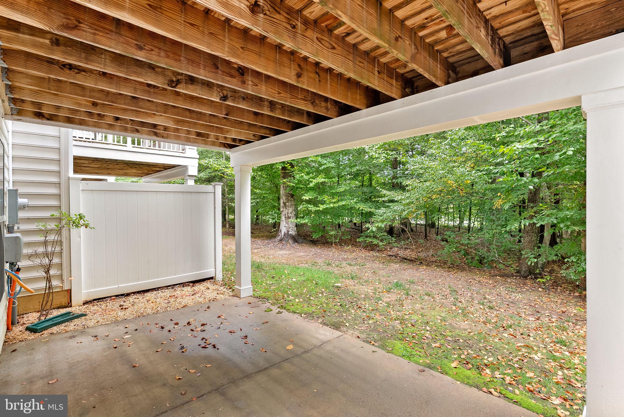 20281 Center Brook Square Sterling, VA 20165 - Photo 42 of 51 a backyard of a house with large trees and plants