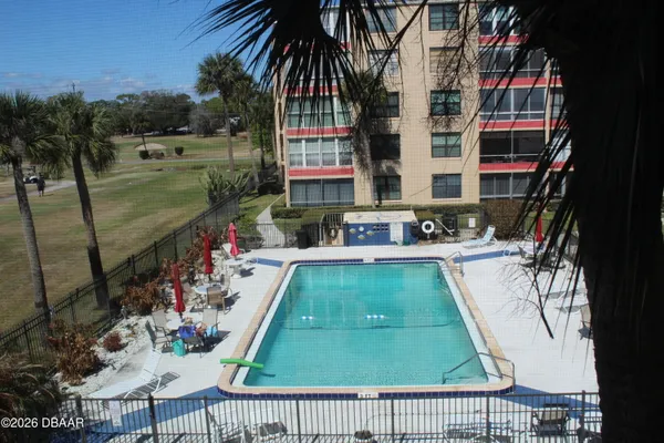 swimming pool view with a outdoor seating space