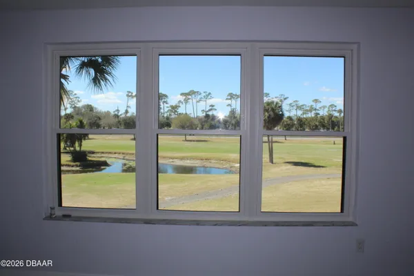 a view of a room that has a painting on the wall