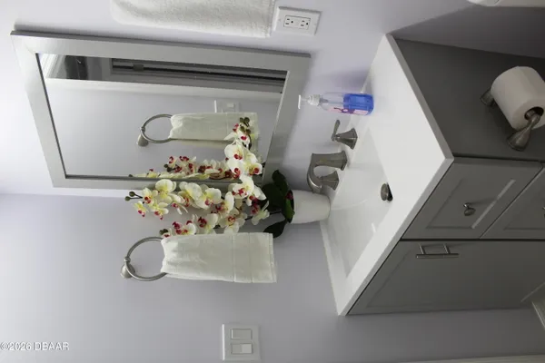 a bathroom with a sink and mirror