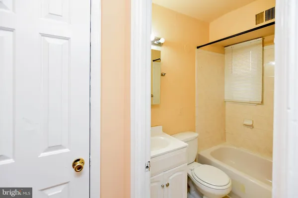 a bathroom with a shower toilet and bathtub
