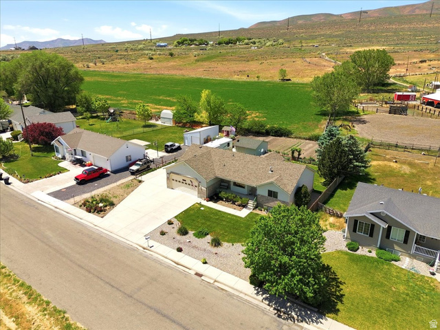 72 Canal Bank Road Garland, UT 84312 - Photo 35 of 40 Ranch-style residence featuring a prominent front lawn with mature trees and landscaping