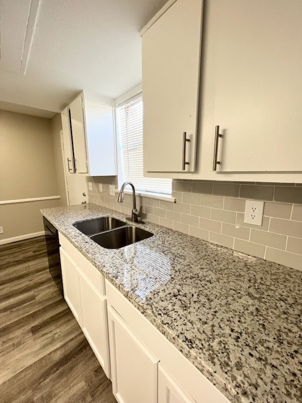 6200 West Tidwell Road, Unit 1109 Houston, TX 77092 - Photo 2 of 18 a kitchen with sink a stove and a wooden floor