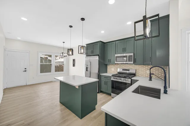 a kitchen that has a cabinets a sink and appliances
