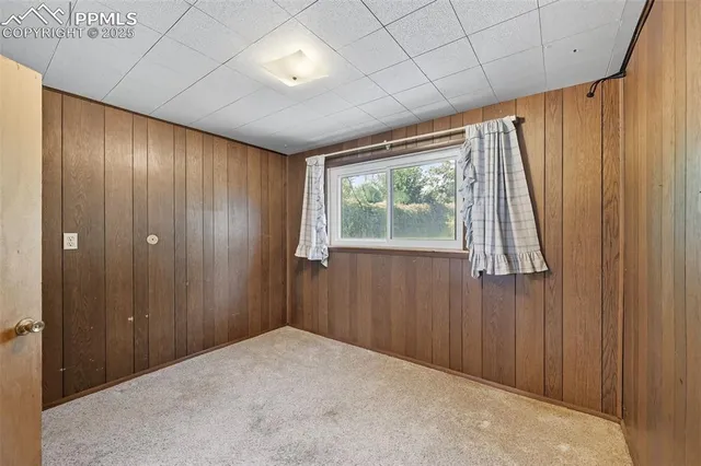 a view of a room with a large window and stairs