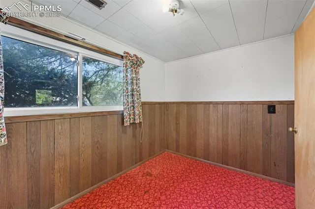 a view of a room with a wooden door and a shower curtain