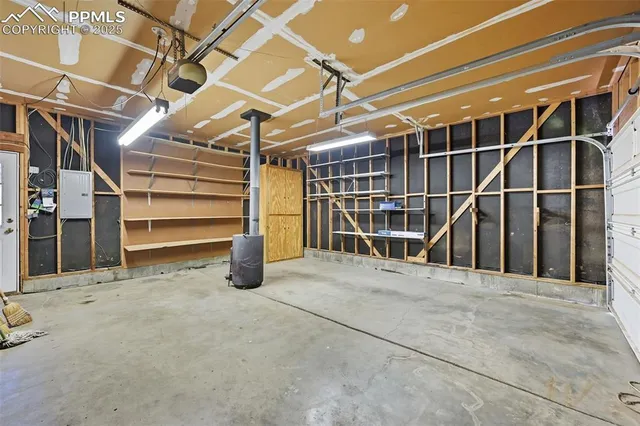 a view of an empty room with wooden shelves