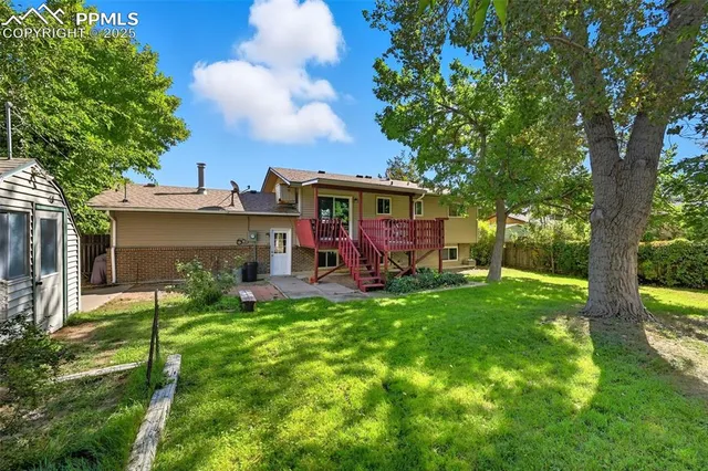 a view of a house with backyard sitting area and garden