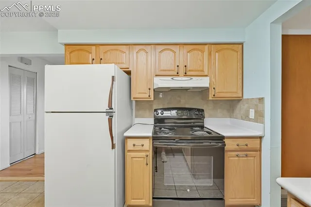 a kitchen with stainless steel appliances granite countertop a refrigerator a stove a sink and a cabinets