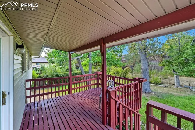 a view of a porch with wooden floor in front of a house