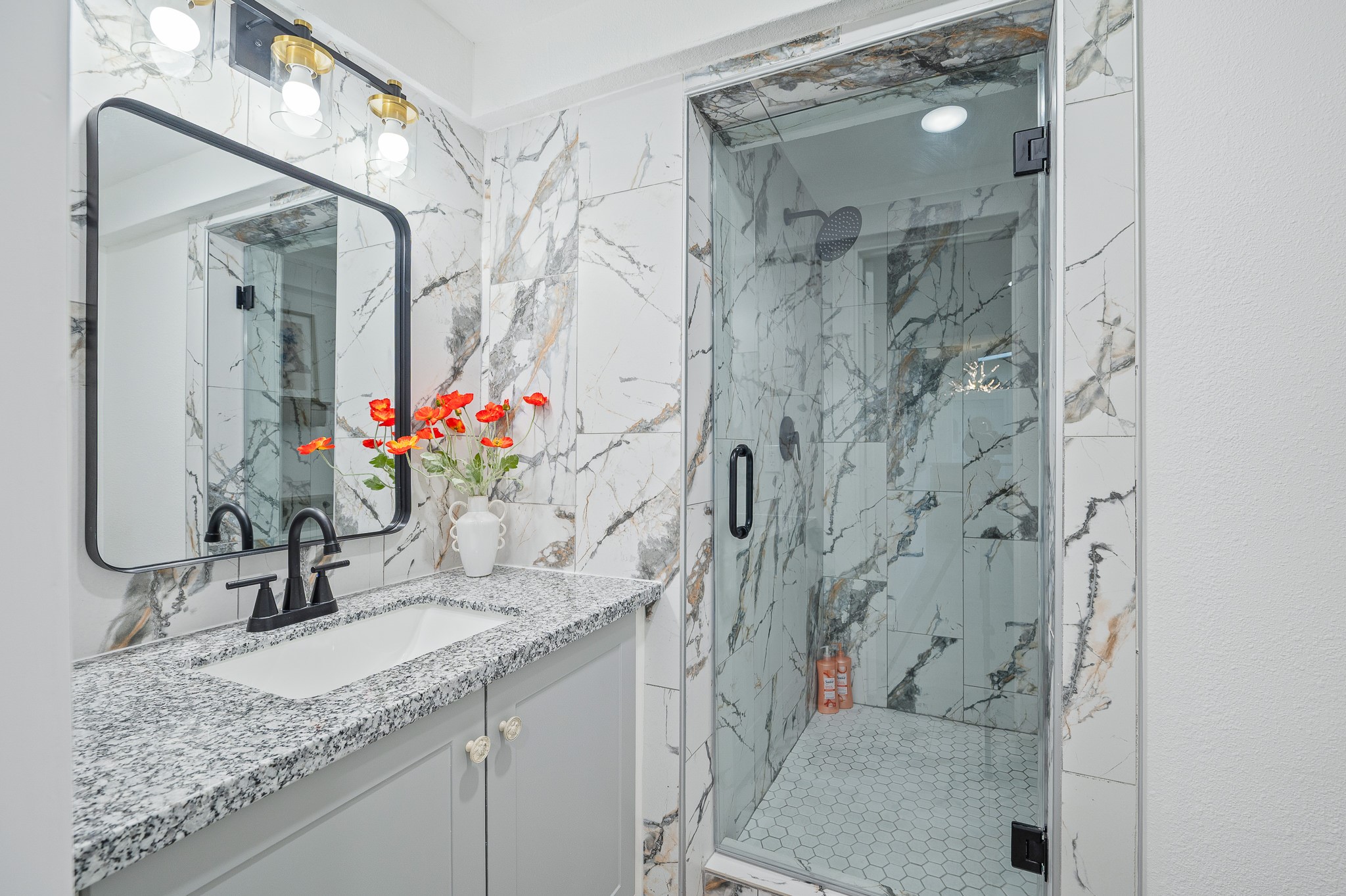 815 5th Street Dickinson, TX 77539 - Photo 27 of 49 a bathroom with a granite countertop sink a toilet and shower