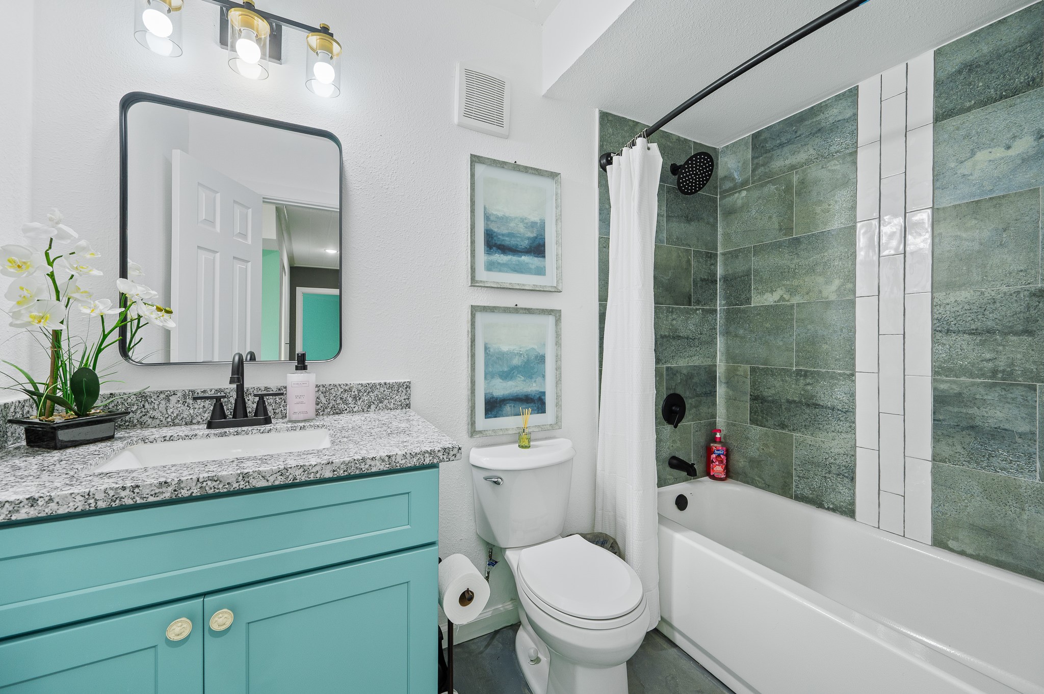 815 5th Street Dickinson, TX 77539 - Photo 32 of 49 a bathroom with a granite countertop toilet a sink and a bathtub