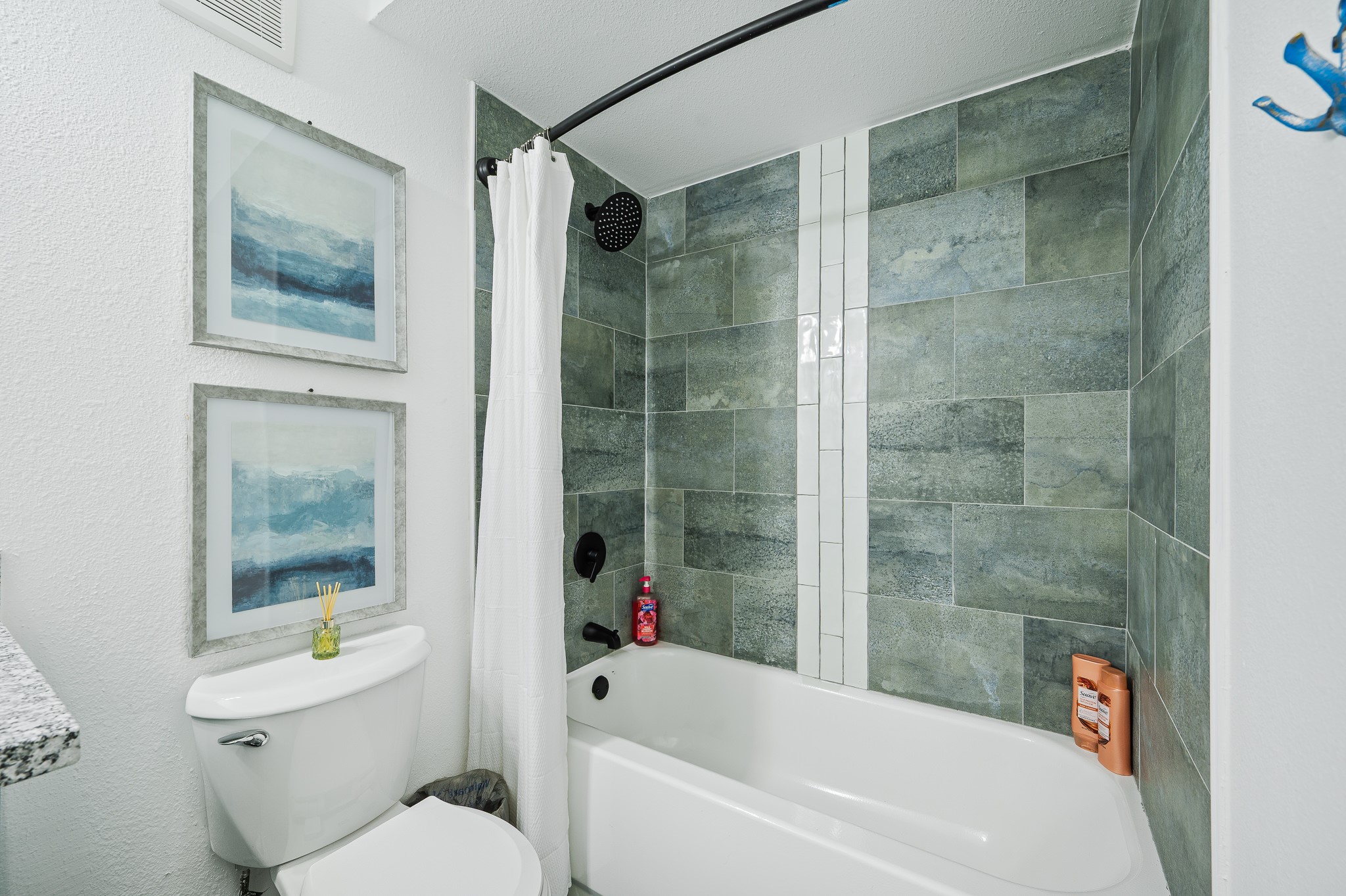 815 5th Street Dickinson, TX 77539 - Photo 33 of 49 a white bath tub sitting next to a white toilet