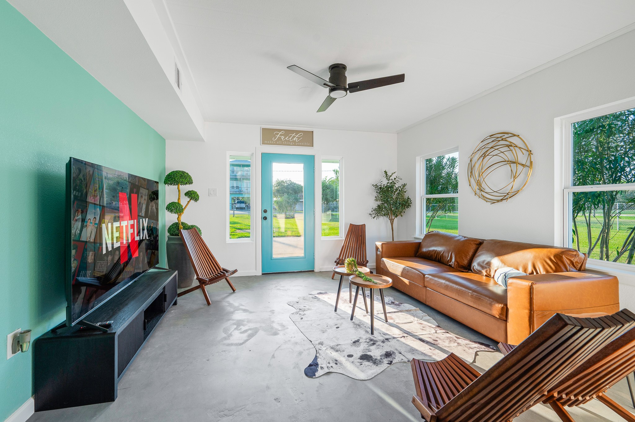 815 5th Street Dickinson, TX 77539 - Photo 35 of 49 a living room with furniture a flat screen tv and a large window