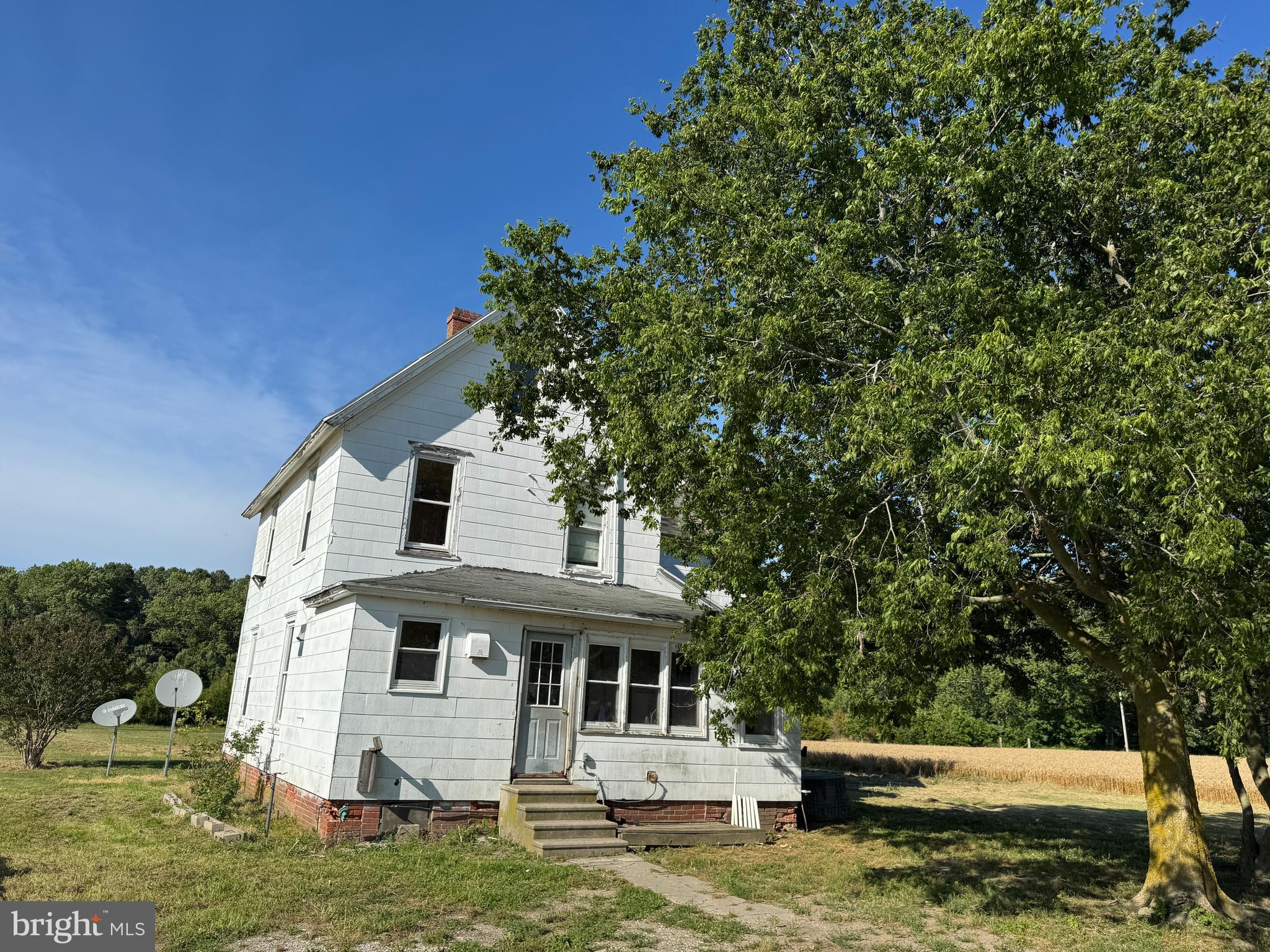 7382 Bullbegger Road Oak Hall, VA 23416 - Photo 5 of 18 a front view of a house with a yard garage and outdoor seating