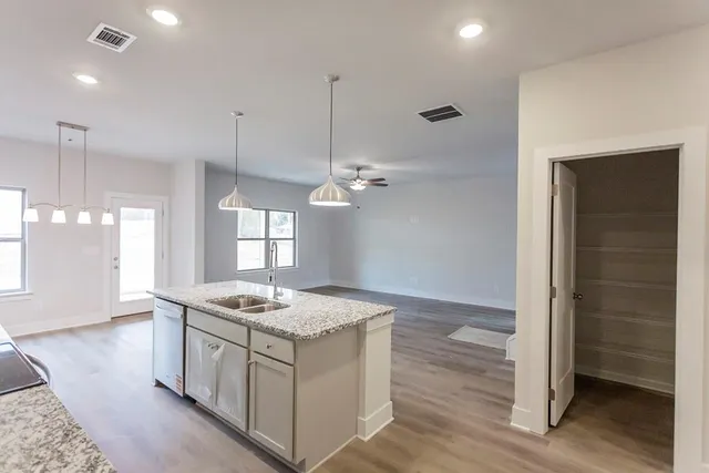 a kitchen that has a lot of cabinets in it