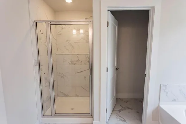 a bathroom with a glass shower door