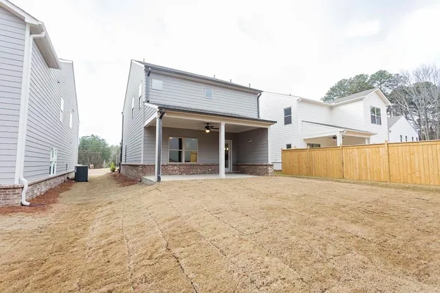 a view of a livingroom with a ceiling fan and window
