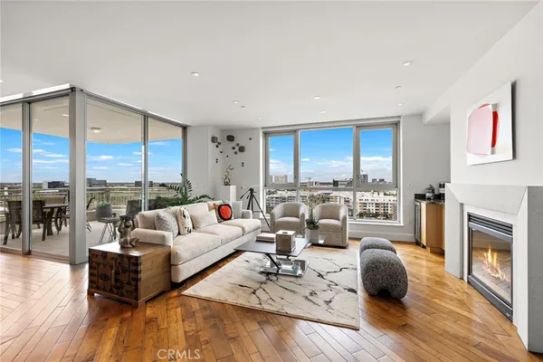 a living room with furniture fireplace and a large window