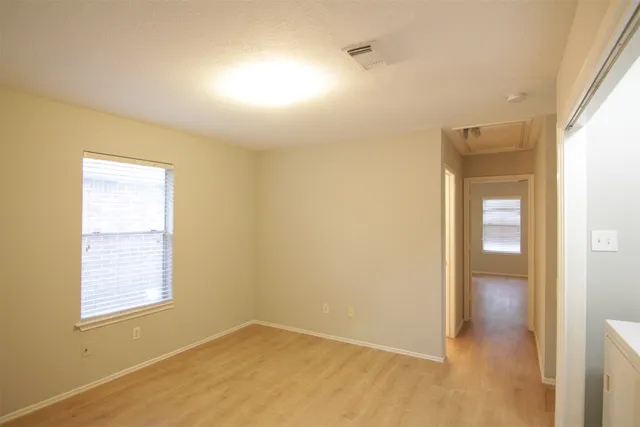 an empty room with windows and closet