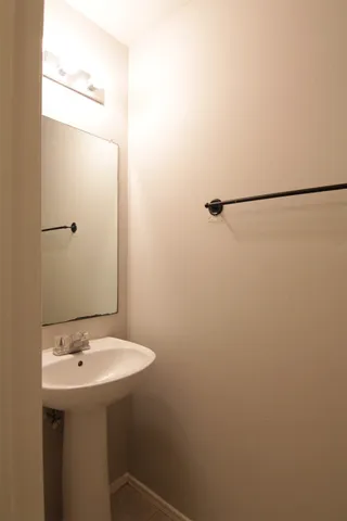 a bathroom with a sink and mirror