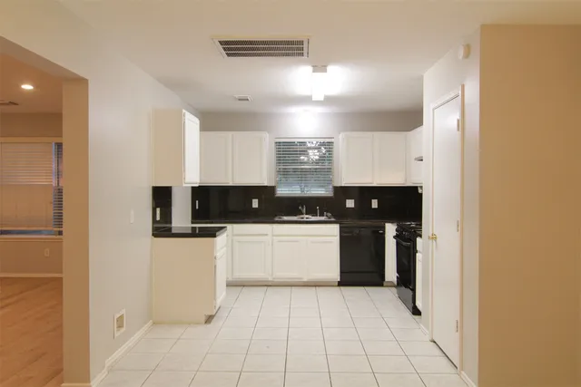 a kitchen with a sink cabinets and appliances