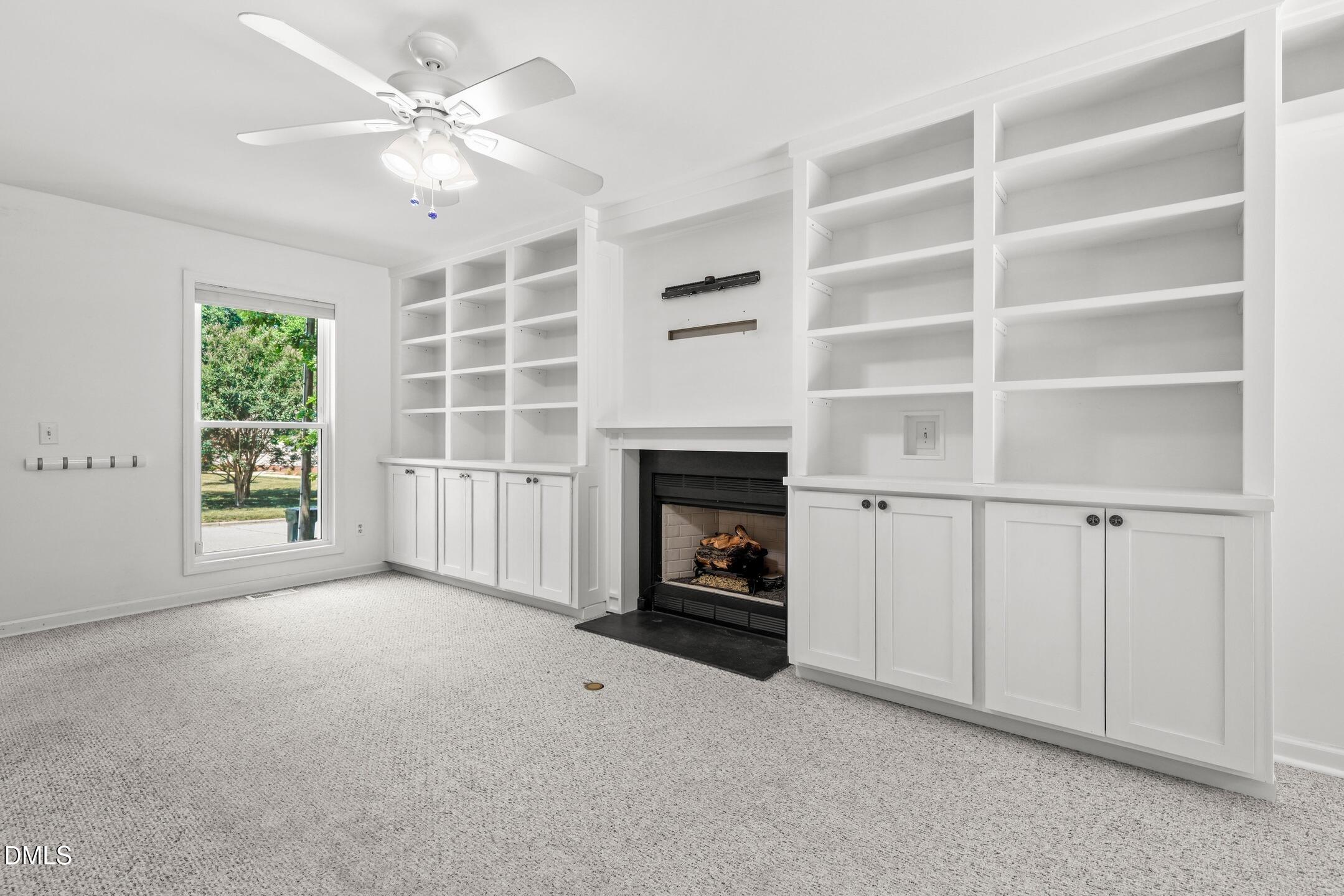 3015 Rennit Court Raleigh, NC 27603 - Photo 7 of 40 an empty room with windows fireplace and fans