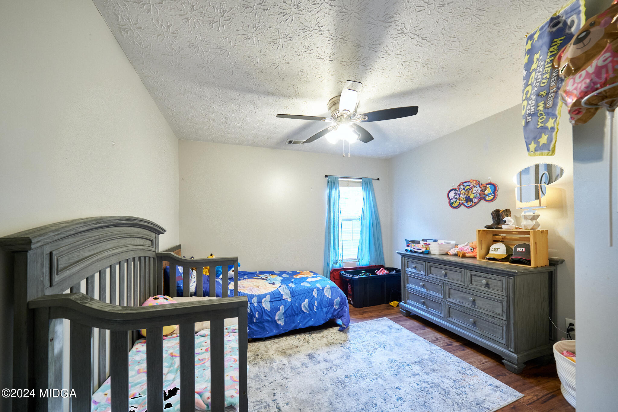 625 Windsor Drive Monroe, GA 30656 - Photo 12 of 27 a bedroom with furniture and a chandelier