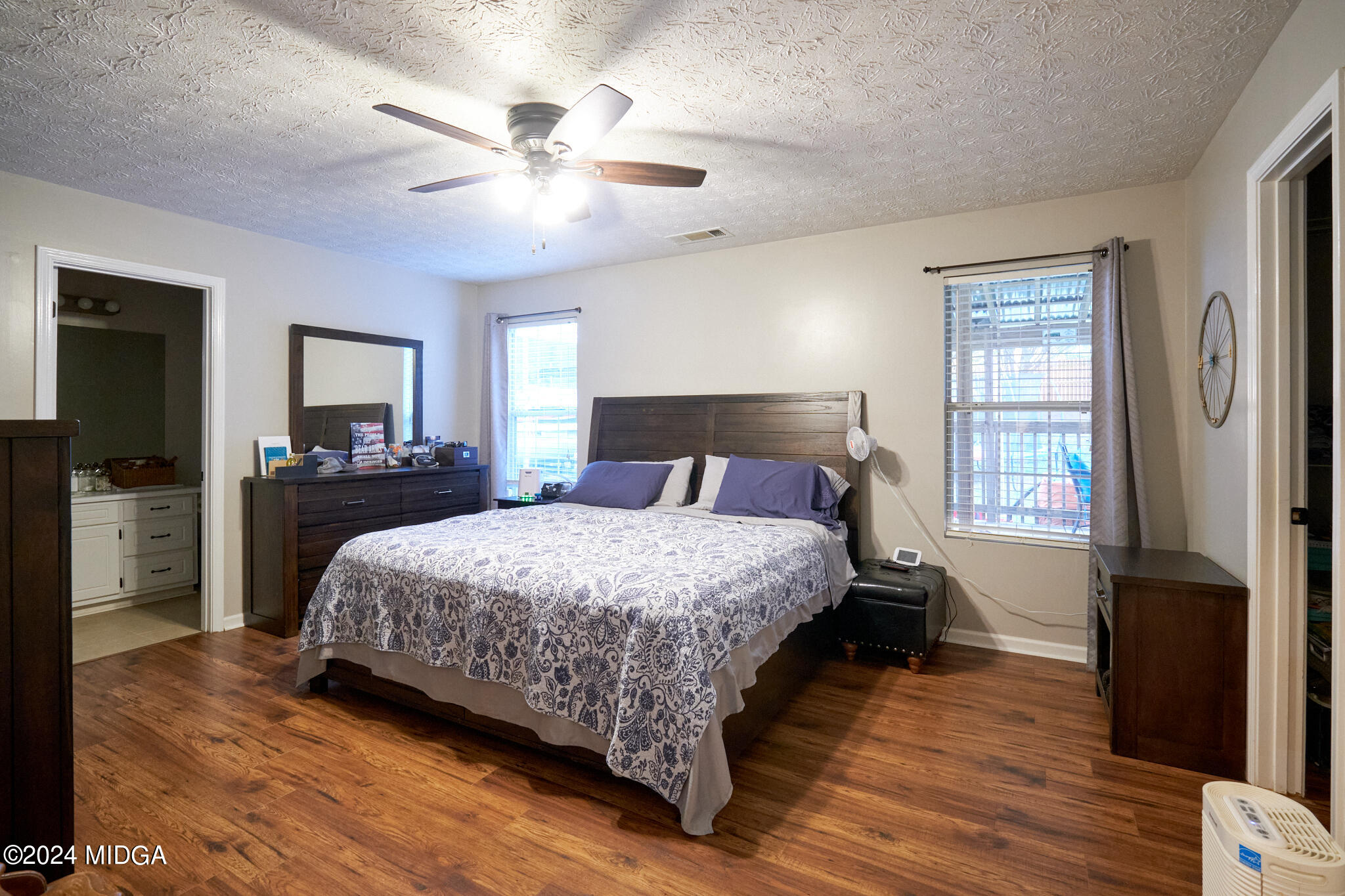 625 Windsor Drive Monroe, GA 30656 - Photo 19 of 27 a bedroom with a bed and wooden floor