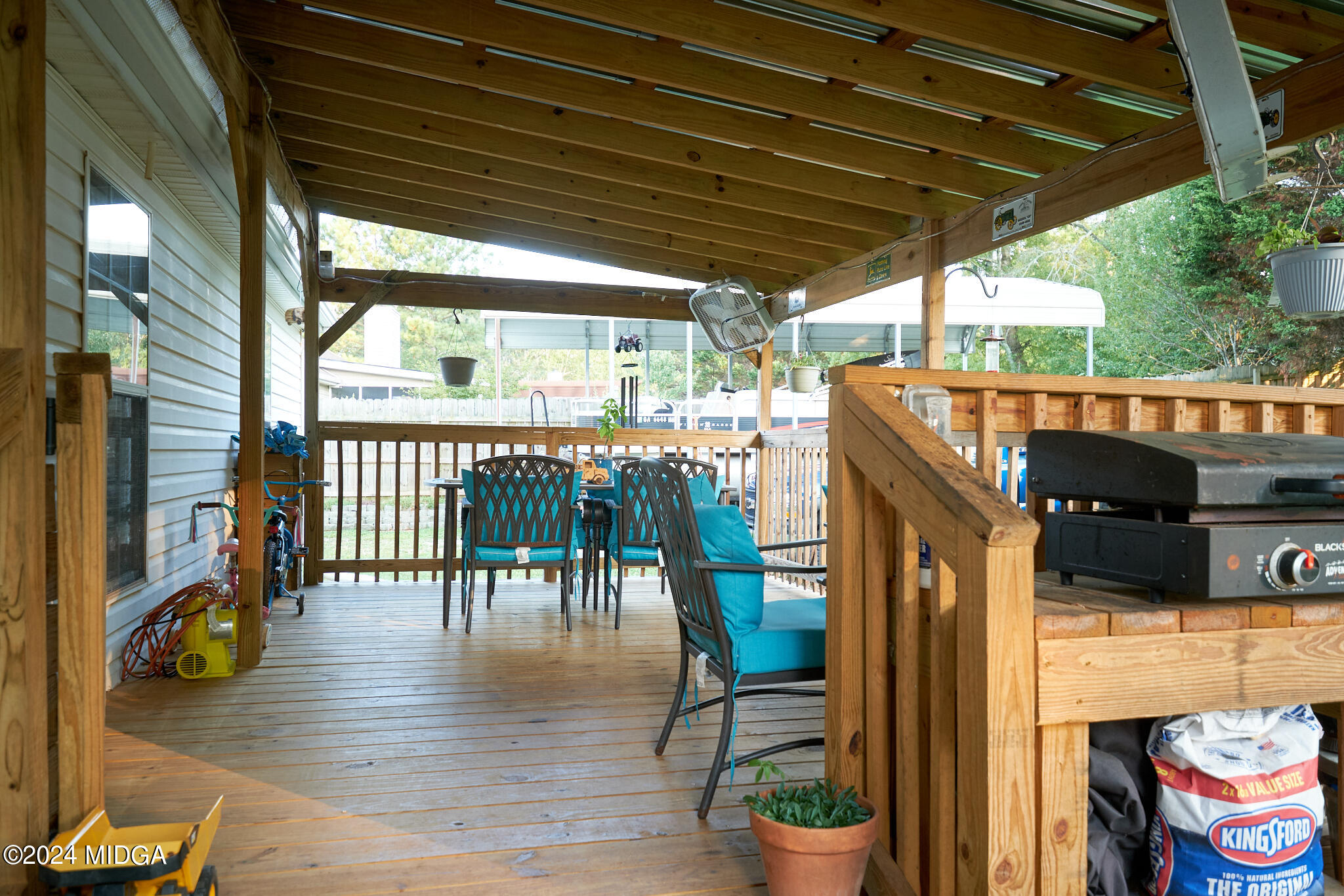 625 Windsor Drive Monroe, GA 30656 - Photo 23 of 27 a view of a patio with table and chairs potted plants with wooden floor and fence