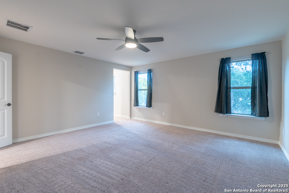 8026 San Mirienda Boerne, TX 78015 - Photo 17 of 29 a view of an empty room with window and chandelier fan
