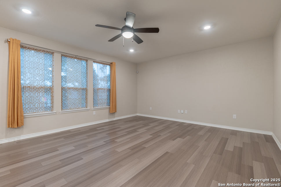 8026 San Mirienda Boerne, TX 78015 - Photo 2 of 29 an empty room with wooden floor and windows