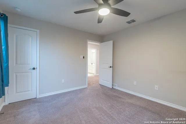 an empty room with a empty space and a ceiling fan