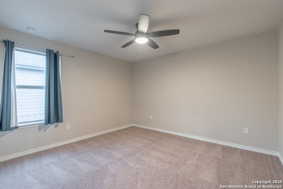 8026 San Mirienda Boerne, TX 78015 - Photo 23 of 29 an empty room with a window and a fan
