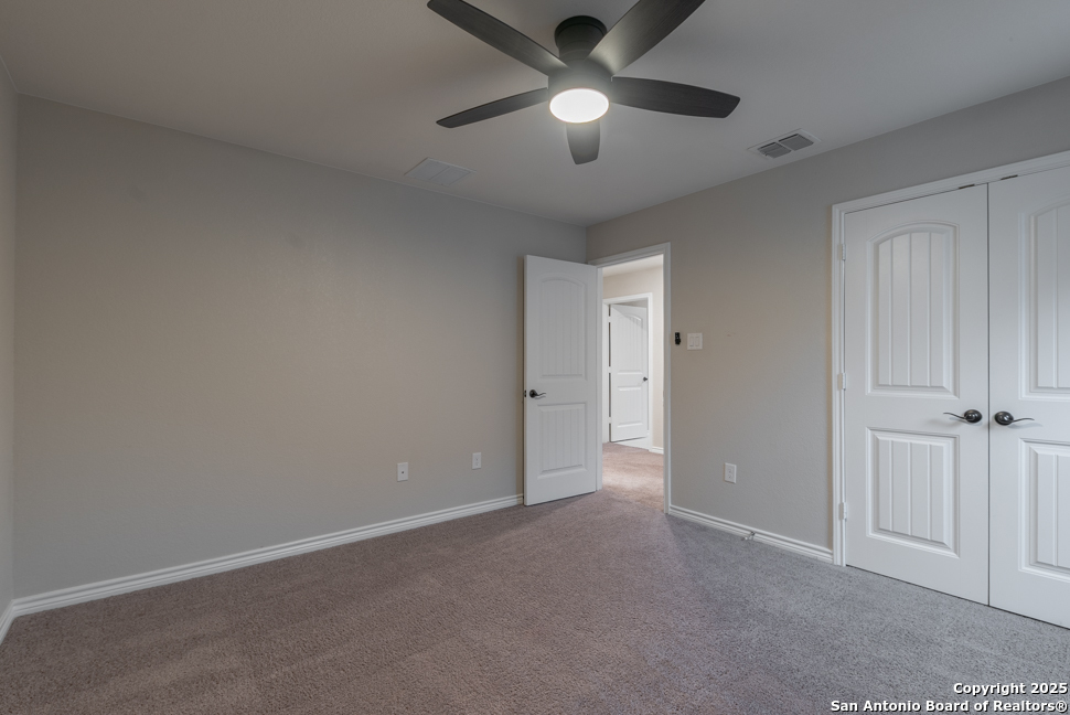 8026 San Mirienda Boerne, TX 78015 - Photo 24 of 29 an empty room with chandelier fan
