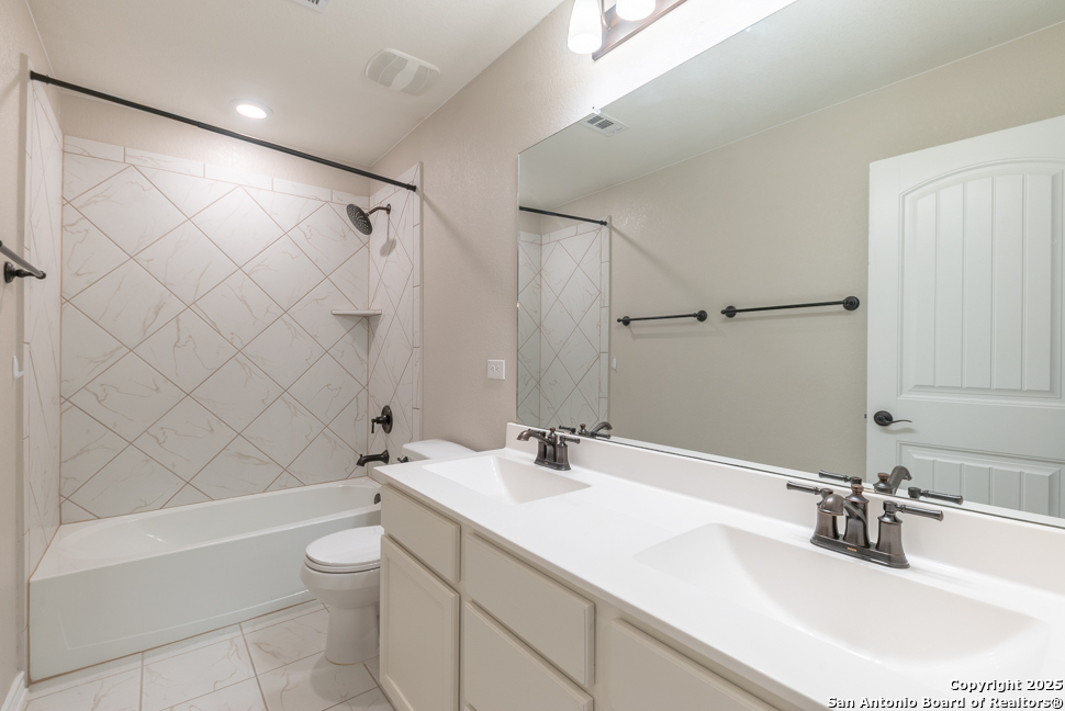 8026 San Mirienda Boerne, TX 78015 - Photo 25 of 29 a bathroom with a sink toilet and shower