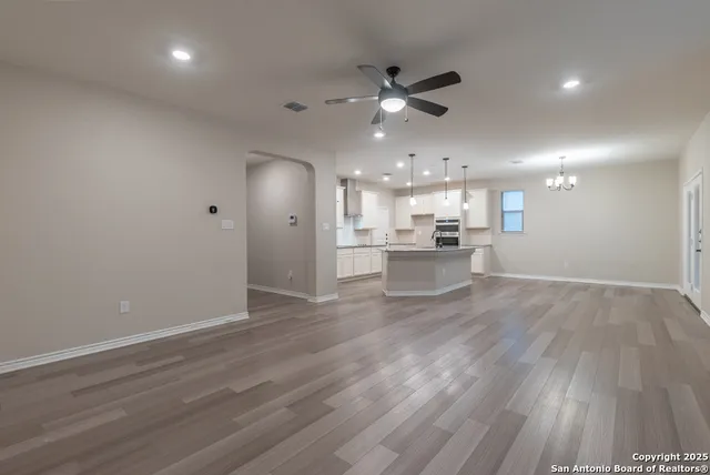 a view of a kitchen with a dishwasher stove top oven and cabinets