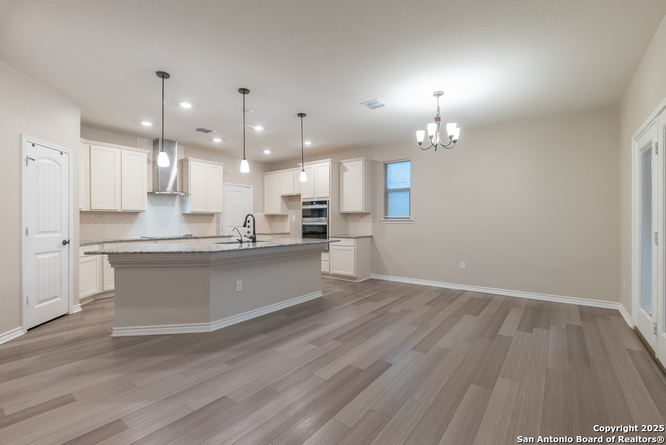 8026 San Mirienda Boerne, TX 78015 - Photo 5 of 29 a large kitchen with granite countertop a large counter top a sink stainless steel appliances and cabinets