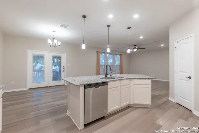 a kitchen with a sink and chandelier