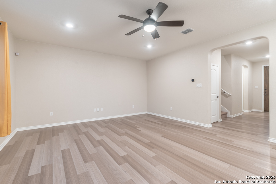 8026 San Mirienda Boerne, TX 78015 - Photo 10 of 29 an empty room with wooden floor and windows